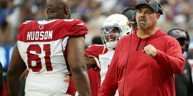 Offensive line coach Sean Kugler of the Arizona Cardinals fist bumps Rodney Hudson after a play during the fourth quarter against the Los Angeles Rams at SoFi Stadium Oct. 3, 2021, in Inglewood, Calif. 