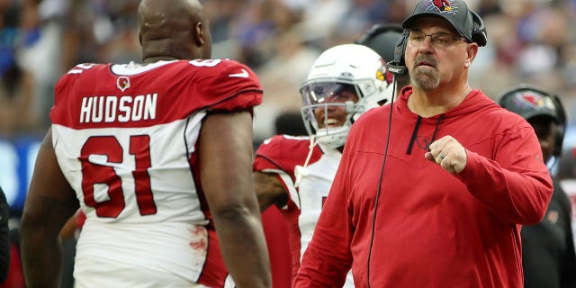 Offensive line coach Sean Kugler of the Arizona Cardinals fist bumps Rodney Hudson after a play during the fourth quarter against the Los Angeles Rams at SoFi Stadium Oct. 3, 2021, in Inglewood, Calif.