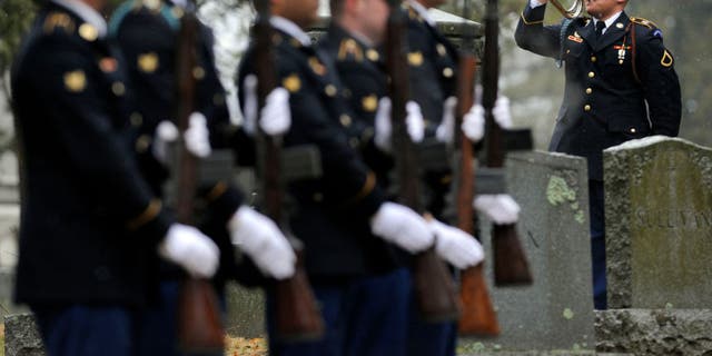 A U.S. Army Honor Guard bugler plays taps at St. Jerome Cemetery in Holyoke, Massachusetts, during a graveside service for Korean War soldier Cpl. Jules Hauterman Jr., whose remains were identified more than 60 years after he was killed in battle.