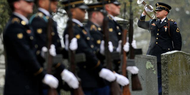 A U.S. Army Honor Guard bugler plays taps at St. Jerome Cemetery in Holyoke, Massachusetts, during a graveside service for Korean War soldier Cpl. Jules Hauterman Jr., whose remains were identified more than 60 years after he was killed in battle.