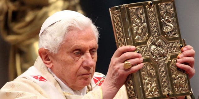 Pope Benedict XVI shows the gospel as he celebrates a mass with newly appointed cardinals at St. Peter's Basilica, on Feb. 19, 2012, in Vatican City, Vatican.