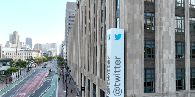 An aerial photo shows a sign posted on the outside of the Twitter headquarters on April 27, 2022 in San Francisco, California. 