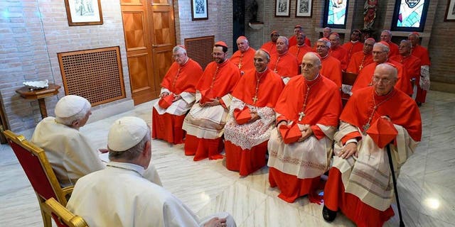 Pope Francis and Pope Emeritus Benedict XVI meet the newly named Cardinals at the Vatican's Mater Ecclesiae Monastery on Aug. 27, 2022, in Vatican City.