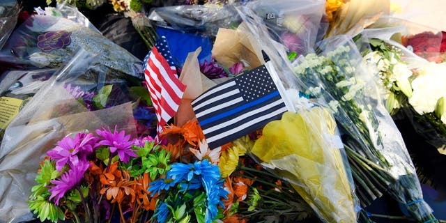 Flowers left on top of the police cruiser belonging to fallen Arvada police officer Dillon Michael Vakoff outside the Arvada Police Headquarters on Sept. 11, 2022 in Arvada, Colorado.