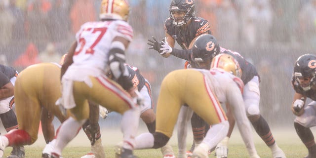 Justin Fields, #1 of the Chicago Bears, prepares to snap the ball against the San Francisco 49ers during the fourth quarter at Soldier Field on Sept. 11, 2022 in Chicago.
