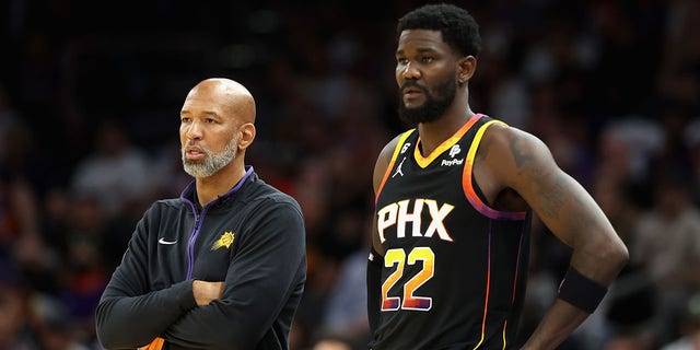 Head coach Monty Williams and Deandre Ayton of the Suns stand on the sidelines during the Dallas Mavericks game on Oct. 19, 2022, in Phoenix.