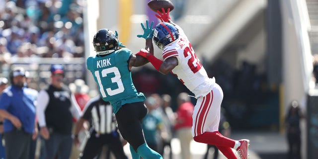 Adoree' Jackson of the New York Giants tips a pass intended for Christian Kirk of the Jaguars at TIAA Bank Field on Oct. 23, 2022, in Jacksonville, Florida.