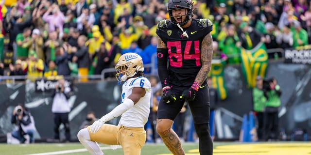 Tight end Cam McCormick #84 of the Oregon Ducks catches a touchdown pass against the UCLA Bruins during the second half at Autzen Stadium on October 22, 2022, in Eugene, Oregon. 