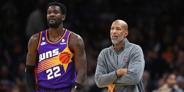 Phoenix Suns head coach Monty Williams, right, stands next to Deandre Ayton, #22, during the second half of an NBA game at the Footprint Center on October 25, 2022 in Phoenix.  The Suns defeated the Warriors 134-105. 