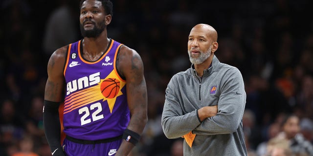 Phoenix Suns head coach Monty Williams, right, stands next to Deandre Ayton, #22, during the second half of an NBA game at the Footprint Center on October 25, 2022 in Phoenix.  The Suns defeated the Warriors 134-105. 