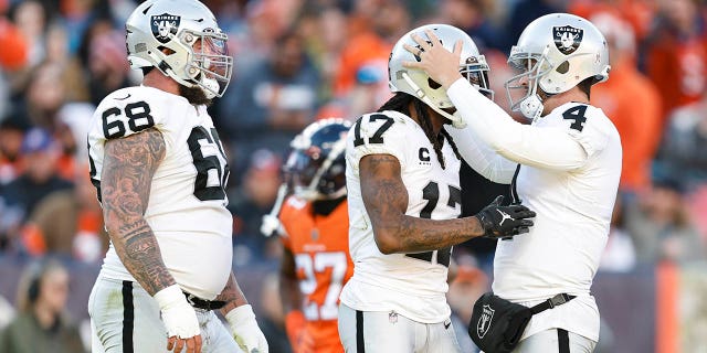 Las Vegas Raiders' Davante Adams (17) celebrates with Derek Carr (4) after catching a touchdown pass during a game against the Denver Broncos at Empower Field At Mile High on November 20, 2022 in Denver, Colorado.