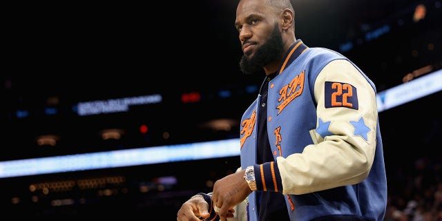 Los Angeles Lakers No. 6 LeBron James watches from the sideline during the first half of the NBA game against the Phoenix Suns at the Footprint Center on November 22, 2022 in Phoenix, Arizona.