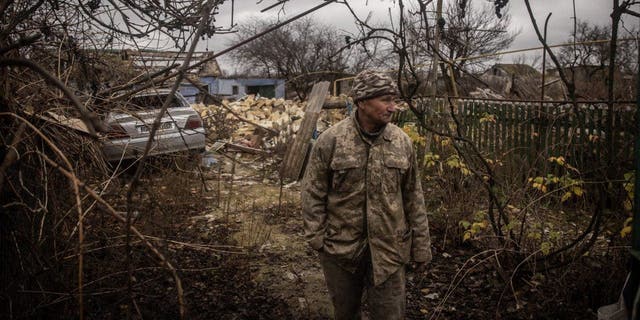 Anatoly Sikoza who buried the bodies stands amid the rubble of a house where Russian forces killed seven men and one woman, hands bound, blindfolded and shot at close range, before blowing up the site in a bid to cover the killings in a village on the outskirts of Kherson on Nov. 27, 2022, in Kherson, Ukraine. 