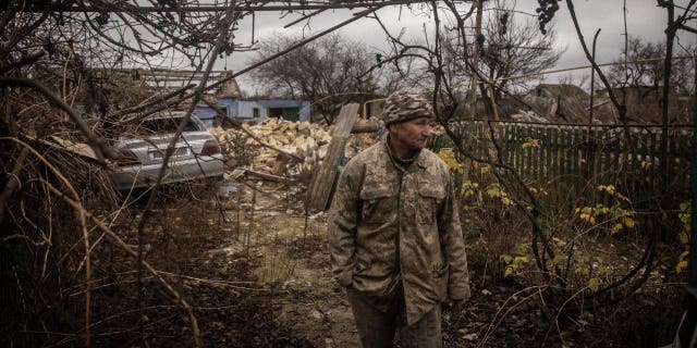 Anatoly Sikoza who buried the bodies stands amid the rubble of a house where Russian forces killed seven men and one woman, hands bound, blindfolded and shot at close range, before blowing up the site in a bid to cover the killings in a village on the outskirts of Kherson on Nov. 27, 2022, in Kherson, Ukraine. 