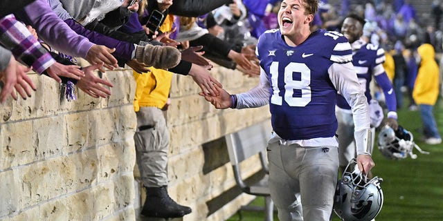 Quarterback Will Howard of the Kansas State Wildcats celebrates with K-State fans after beating the Kansas Jayhawks at Bill Snyder Family Football Stadium Nov. 26, 2022, in Manhattan, Kan. 