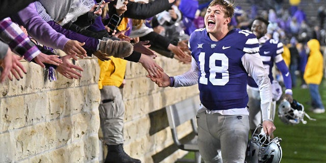 Quarterback Will Howard of the Kansas State Wildcats celebrates with K-State fans after beating the Kansas Jayhawks at Bill Snyder Family Football Stadium Nov. 26, 2022, in Manhattan, Kan. 