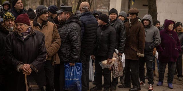 Ukraine begins new evacuations in Kherson as elevated hostilities anticipated 2 Residents wait to receive humanitarian aid in Kherson city center on Dec. 1, 2022, in Kherson, Ukraine.