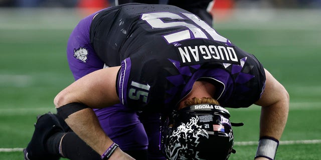 Quarterback Max Duggan of the TCU Horned Frogs reacts after being hit after a pass in the second half against the Kansas State Wildcats on December 3, 2022, in Arlington, Texas.
