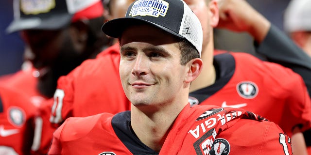 Stetson Bennett #13 of the Georgia Bulldogs celebrates after defeating the LSU Tigers in the SEC Championship game at Mercedes-Benz Stadium on December 03, 2022, in Atlanta, Georgia.