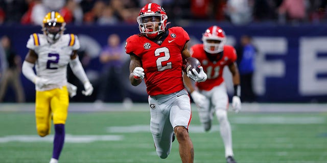 Kendall Milton #2 of the Georgia Bulldogs breaks away for a long run against the LSU Tigers during the second half of the SEC Championship game at Mercedes-Benz Stadium on December 3, 2022 in Atlanta, Georgia. 