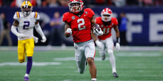 Kendall Milton #2 of the Georgia Bulldogs breaks away for a long run against the LSU Tigers during the second half of the SEC Championship game at Mercedes-Benz Stadium on December 3, 2022 in Atlanta, Georgia.