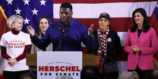 Georgia Republican Senate candidate Herschel Walker poses with (L-R) Georgia Republican National Committeewoman Ginger Howard, Republican National Committee Chairwoman Rona McDaniel, Walker's wife Julie Blanchard and former U.S. Ambassador to the United Nations Nikki Haley during a campaign rally on December 5, 2022. Kennesaw, Georgia.