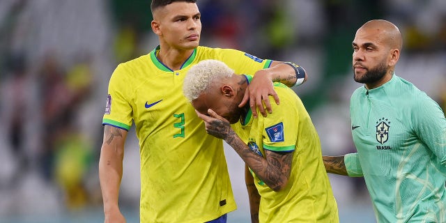 Neymar, of Brazil, reacts with Thiago Silva, left, and Dani Alves after the loss via a penalty shootout during the FIFA World Cup Qatar 2022 quarterfinal match between Croatia and Brazil at Education City Stadium on Dec. 9, 2022 in Al Rayyan, Qatar.