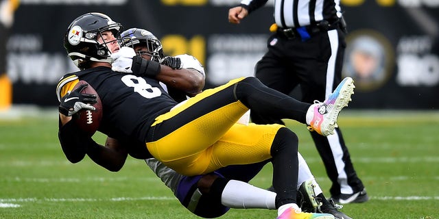 Kenny Pickett, #8 of the Pittsburgh Steelers, is sacked by Roquan Smith, #18 of the Baltimore Ravens, in the first quarter of the game at Acrisure Stadium on Dec. 11, 2022 in Pittsburgh.