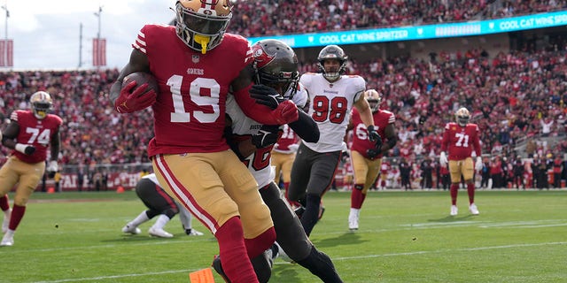 Deebo Samuel of the San Francisco 49ers scores a touchdown against Logan Ryan of the Tampa Bay Buccaneers at Levi's Stadium on Dec. 11, 2022, in Santa Clara, California.