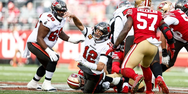 Tom Brady of the Tampa Bay Buccaneers attempts to pass as he is tackled by Nick Bosa of the San Francisco 49ers at Levi's Stadium on Dec. 11, 2022, in Santa Clara, California.