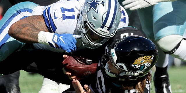 Mike Parsons #11 of the Dallas Cowboys sacks Trevor Lawrence #16 of the Jacksonville Jaguars in the first quarter of the game at TIAA Bank Field on December 18, 2022 in Jacksonville, Florida.