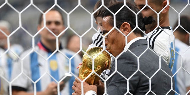 Nusret Gökçe, nicknamed Salt Bae, kisses the FIFA World Cup Qatar 2022 winner's trophy after the FIFA World Cup Qatar 2022 final between Argentina and France at Lusail Stadium Dec. 18, 2022, in Lusail City, Qatar. 