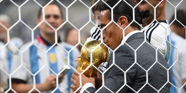 Nusret Gökçe, nicknamed Salt Bae, kisses the FIFA World Cup Qatar 2022 winner's trophy after the FIFA World Cup Qatar 2022 final between Argentina and France at Lusail Stadium Dec. 18, 2022, in Lusail City, Qatar. 