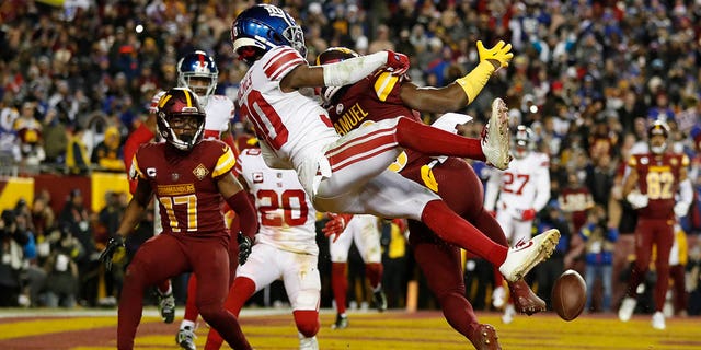 Darnay Holmes #30 of the New York Giants breaks up a pass intended for Curtis Samuel, #10 of the Washington Commanders during the 4th quarter at FedExField on December 18, 2022 in Landover, Maryland. 
