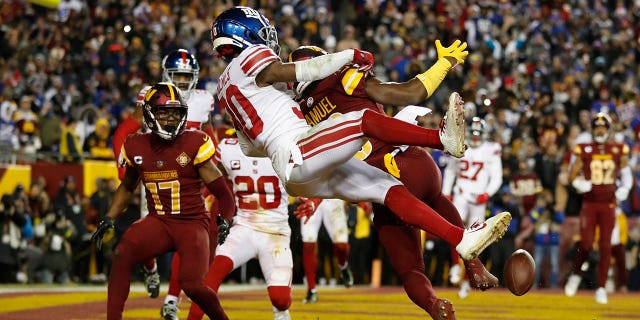 Darnay Holmes #30 of the New York Giants breaks up a pass intended for Curtis Samuel, #10 of the Washington Commanders during the 4th quarter at FedExField on December 18, 2022 in Landover, Maryland. 