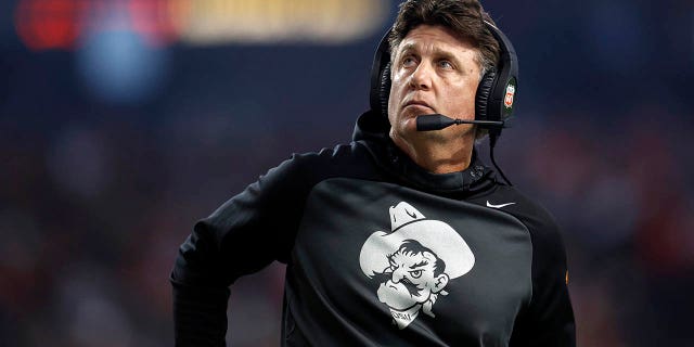 Oklahoma State Cowboys head coach Mike Gundy looks on during the first half of the Guaranteed Rate Bowl against the Wisconsin Badgers at Chase Field on December 27, 2022 in Phoenix.