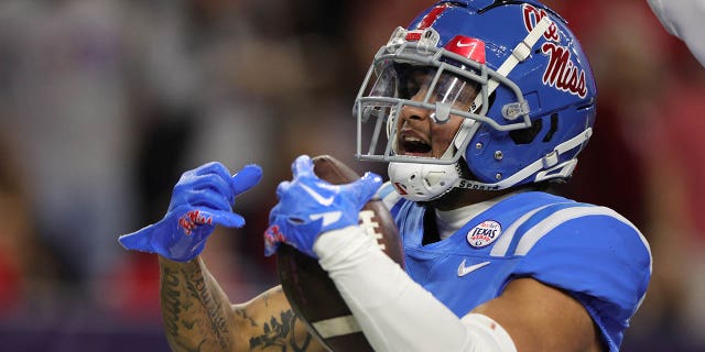 Jordan Watkins, number 11 of the Mississippi Rebels, celebrates his receiving for a touchdown ahead of Marquis Waters, number 9 of the Texas Tech Red Raiders, during the second half at NRG Stadium on December 28, 2022 in Houston.