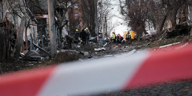 Emergency workers gather at the scene of a blast on New Year’s Eve, December 31, 2022 in Kyiv, Ukraine. 