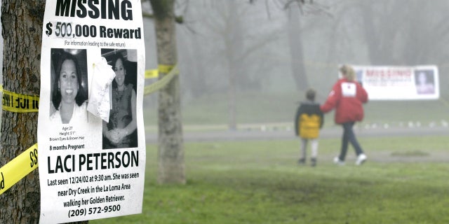 A missing person's poster offering a $500,000 reward for the safe return of Laci Peterson is displayed on a tree at the East La Loma Park Jan. 4, 2003, in Modesto, Calif.