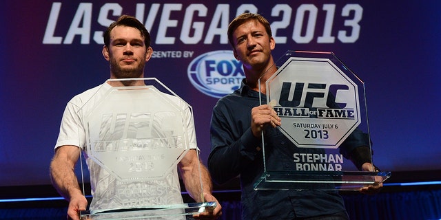 Forrest Griffin and Stephan Bonnar pose for photos with their UFC Hall of Fame plaques during the UFC Fan Expo Las Vegas 2013 at the Mandalay Bay Convention Center on July 6, 2013 in Las Vegas, Nevada.  