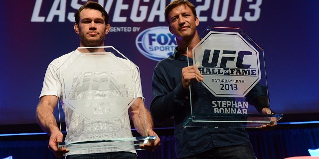Forrest Griffin and Stephan Bonnar pose for photos with their UFC Hall of Fame plaques during the 2013 UFC Fan Expo Las Vegas at the Mandalay Bay Convention Center on July 6, 2013 in Las Vegas, Nevada.
