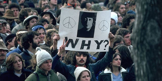 December 1980: Fans of John Lennon hold a vigil after he was shot dead by a fan on December 8th at his home in New York City.  