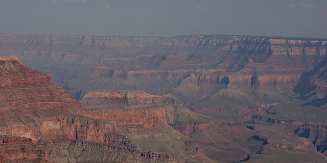 FILE - A tourist helicopter flies over Grand Canyon National Park in this aerial photograph taken above Grand Canyon, Arizona, U.S., on Thursday, June 25, 2015.