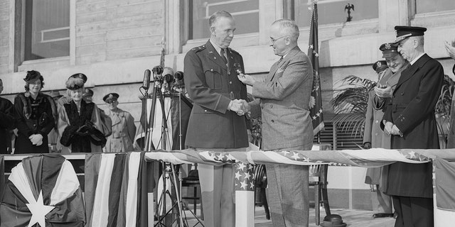 In ceremonies held in the Pentagon Court, President Harry Truman (center, at right) awards an Oak Leaf Cluster to the Distinguished Service Cross to General George C. Marshall, retiring chief of staff.
