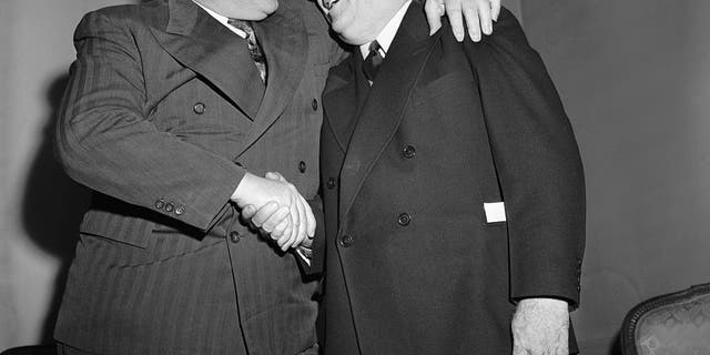 Bert Bell of Philadelphia, right, who was named the new czar of the National Football League in 1946, to succeed Elmer Layden, is congratulated by Steve Owen, coach of the New York Giants, at a meeting of the league's officials.