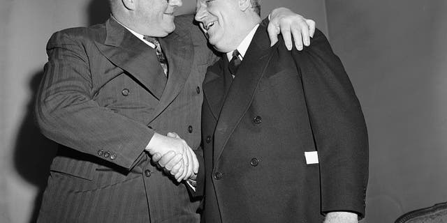 Bert Bell of Philadelphia, right, who was named the new czar of the National Football League in 1946, to succeed Elmer Layden, is congratulated by Steve Owen, coach of the New York Giants, at a meeting of the league's officials.