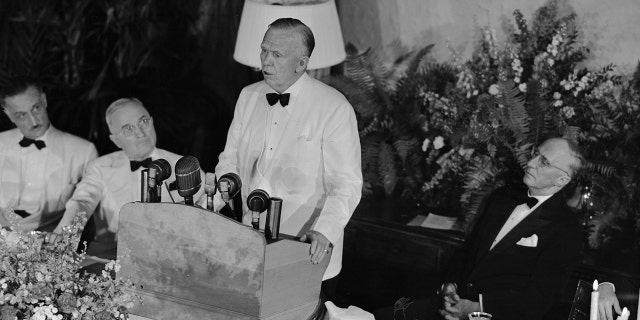 Former Secretary of State George C. Marshall (at the podium) speaks on the second anniversary of his address at Harvard University, in which he outlined the Marshall Plan for the economic recovery of Europe.