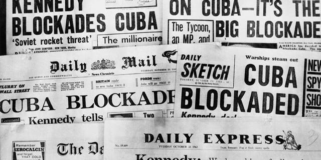 Headlines of Britain's daily newspapers on Oct. 23 announcing President Kennedy's blockade of Cuba. U.S. planes and ships, armed with orders to shoot if necessary, began taking up positions in the Caribbean on Oct. 22 to cut off shipments of Communist offensive weapons to Cuba. Kennedy told the nation that Soviet missiles and other weapons had turned Cuba into an armed camp capable of hurling destruction into the heart of America.