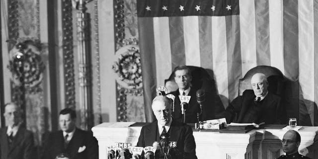 President Franklin D. Roosevelt is pictured during the dramatic moments before the joint session of Congress, Dec. 8, 1941, as he asked Congress to declare war against Japan for its "unprovoked and dastardly attack." On the right is his son, James Roosevelt. In the background are Vice President Henry A. Wallace (left) and Speaker of the House Sam Rayburn. Both the Senate and the House complied with FDR's request almost immediately. 