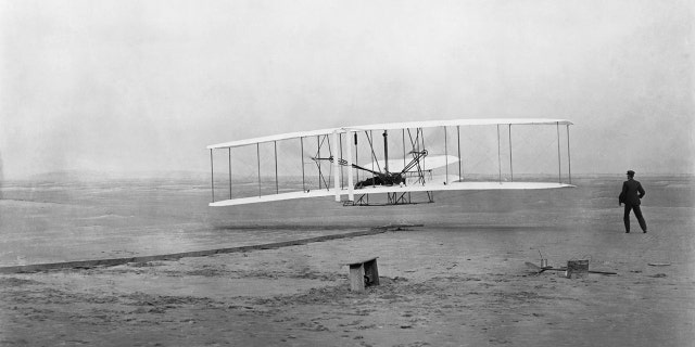 The first flyer takes off from Kill Devil Hill, with Orville Wright at the controls, while his brother Wilbur looks on, on Dec. 17, 1903.